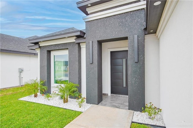 8043 N 50th St, Mcallen, TX 78504 - doorway to property featuring a lawn, a shingled roof, and stucco siding