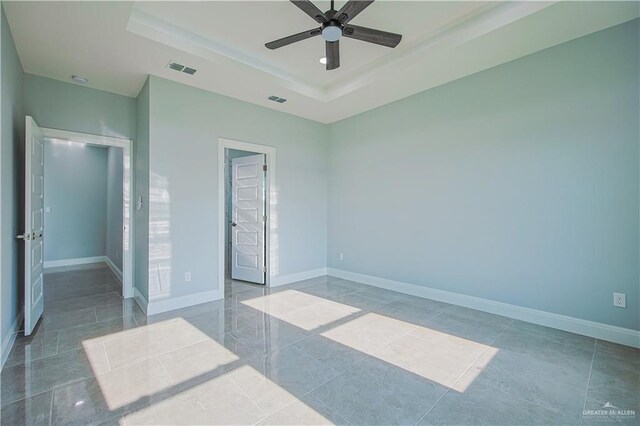 8043 N 50th St, Mcallen, TX 78504 - unfurnished bedroom featuring a raised ceiling, baseboards, a ceiling fan, and visible vents