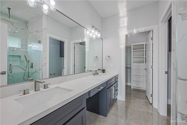 8043 N 50th St, Mcallen, TX 78504 - bathroom featuring a notable chandelier, a marble finish shower, a sink, and a spacious closet