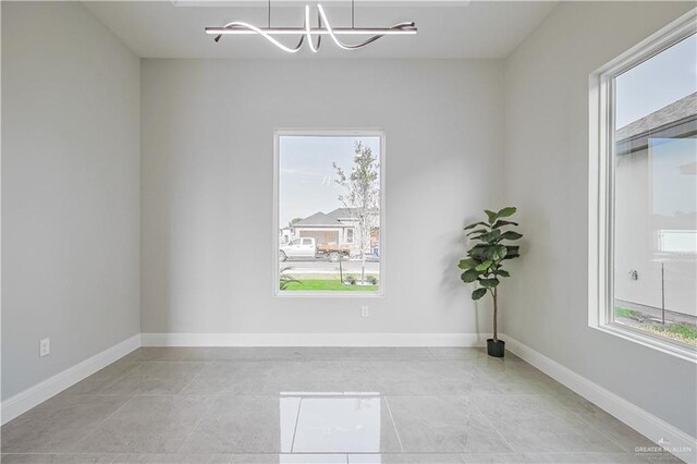 8043 N 50th St, Mcallen, TX 78504 - unfurnished room featuring an inviting chandelier, baseboards, and plenty of natural light