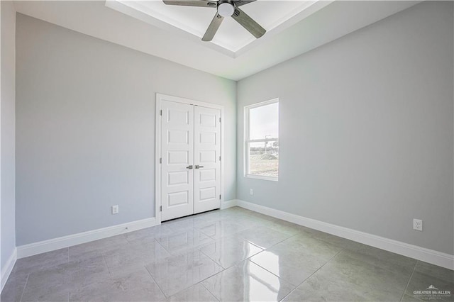8043 N 50th St, Mcallen, TX 78504 - unfurnished bedroom with a tray ceiling, ceiling fan, baseboards, and a closet
