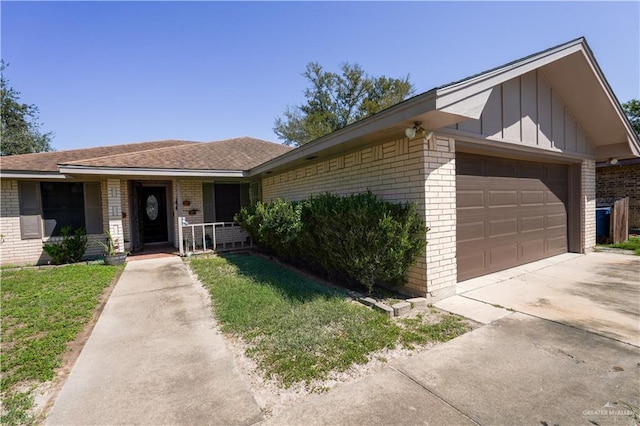 2020 N Lark Ave, Mcallen, TX 78504 - view of front of property with brick siding, board and batten siding, a garage, driveway, and a porch