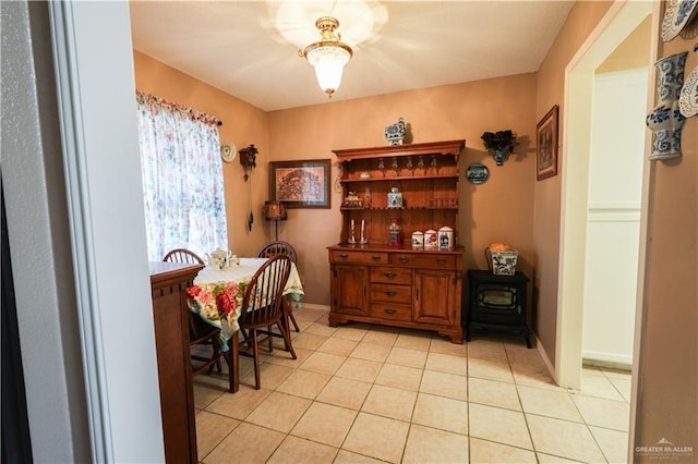 2020 N Lark Ave, Mcallen, TX 78504 - dining area featuring light tile patterned flooring, a wood stove, and baseboards