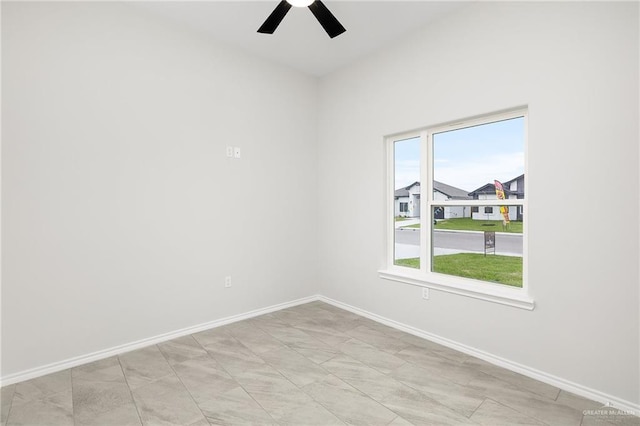 unfurnished room featuring baseboards and ceiling fan