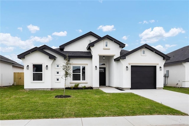 view of front facade featuring stucco siding, an attached garage, concrete driveway, and a front lawn