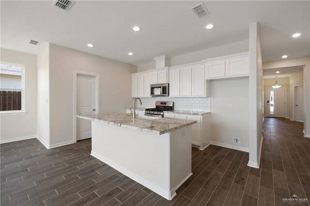 kitchen featuring white cabinets, appliances with stainless steel finishes, dark wood-type flooring, and visible vents
