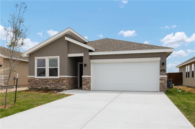 view of front of house with driveway, stone siding, fence, a garage, and stucco siding