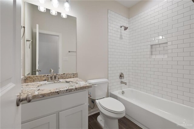 full bath with wood finished floors, toilet, vanity, and washtub / shower combination