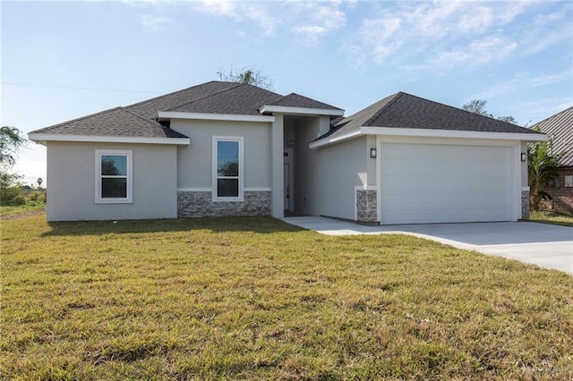 view of front of property featuring a garage and a front yard