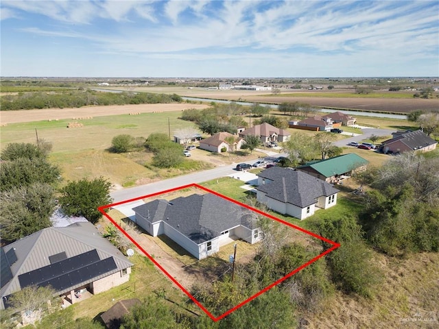 birds eye view of property with a rural view