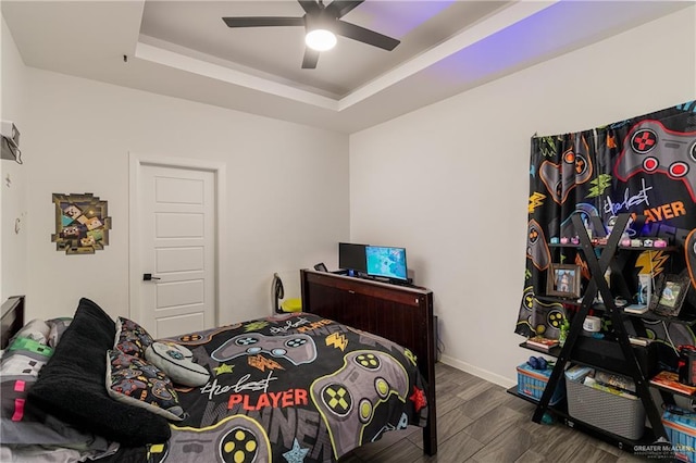 bedroom featuring ceiling fan and a raised ceiling