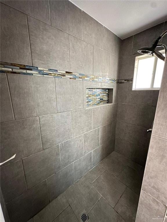 bathroom with a tile shower