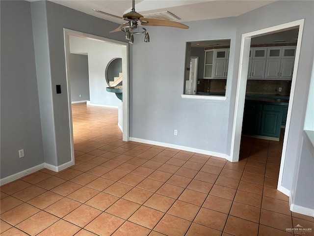 empty room with light tile patterned flooring and ceiling fan