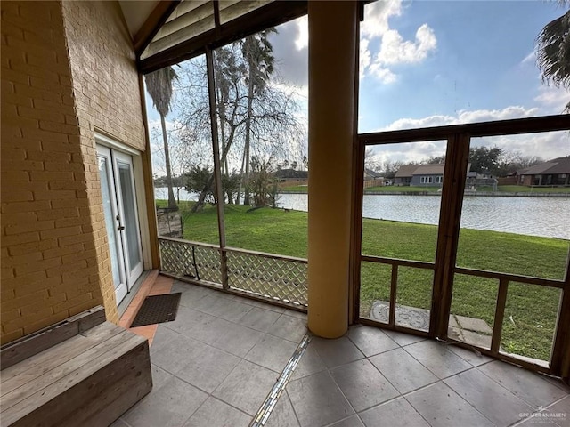 unfurnished sunroom featuring a water view