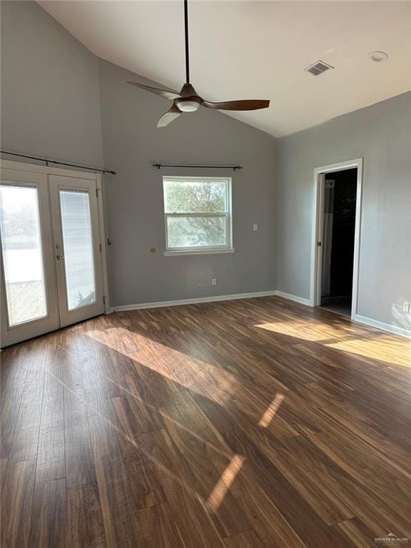 empty room with vaulted ceiling, dark hardwood / wood-style floors, ceiling fan, and french doors