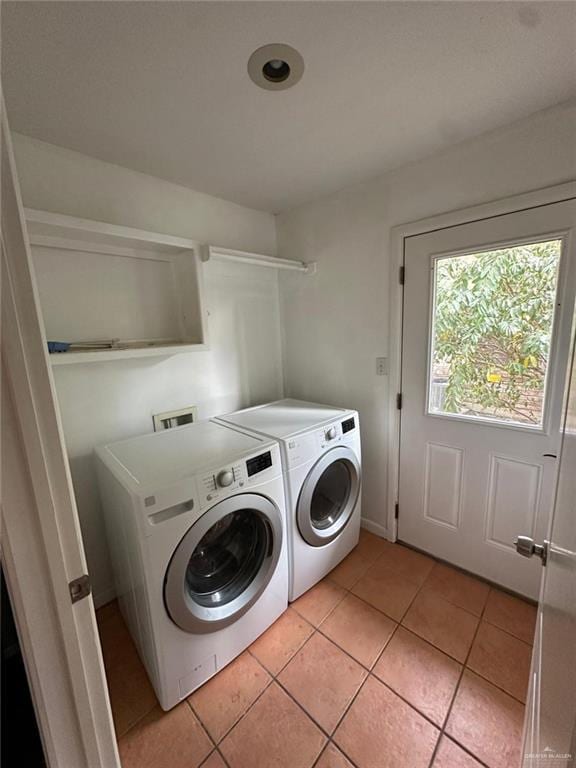 washroom with light tile patterned flooring and washer and clothes dryer