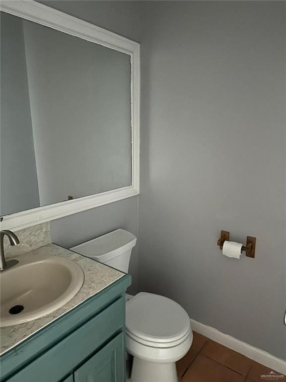 bathroom with vanity, tile patterned floors, and toilet