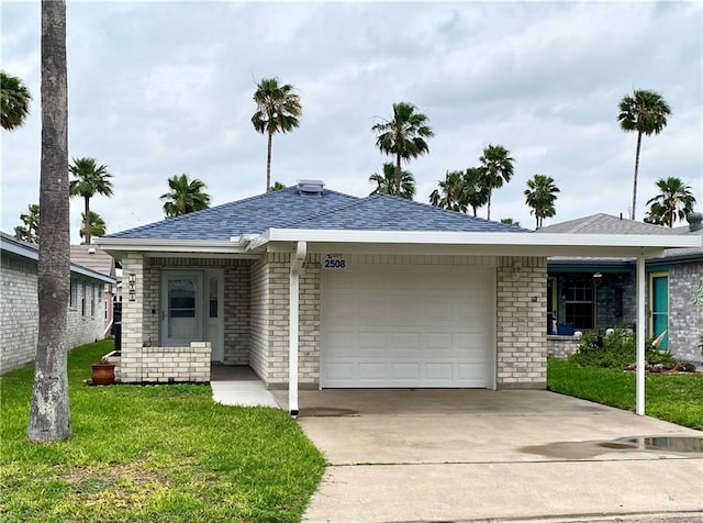 2508 Starling Cir W, Palmview, TX 78572 - ranch-style home with brick siding, an attached garage, a front yard, and driveway