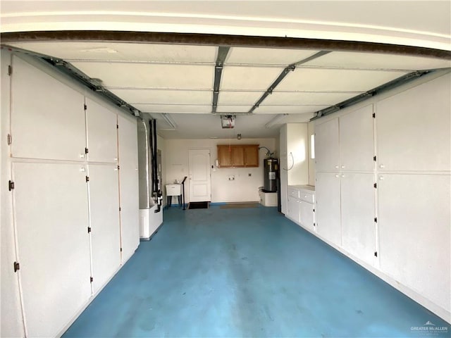 2508 Starling Cir W, Palmview, TX 78572 - garage featuring electric water heater, a sink, and a garage door opener
