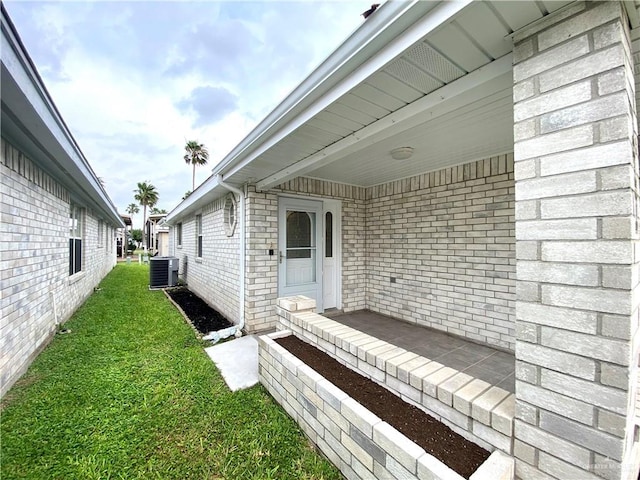 2508 Starling Cir W, Palmview, TX 78572 - entrance to property with central AC unit, brick siding, and a yard