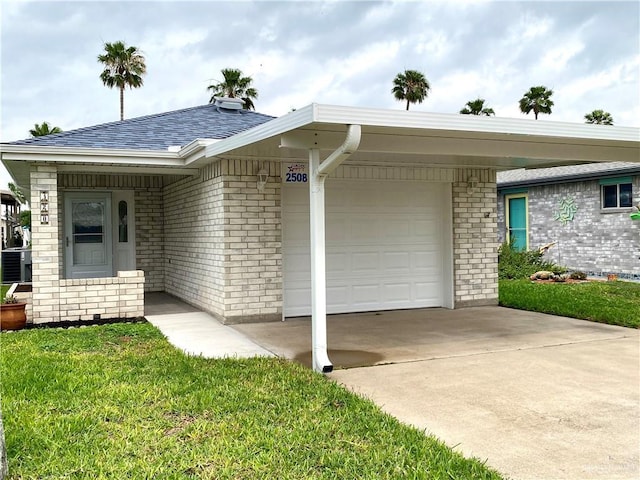 2508 Starling Cir W, Palmview, TX 78572 - single story home with concrete driveway, an attached garage, a front yard, brick siding, and roof with shingles