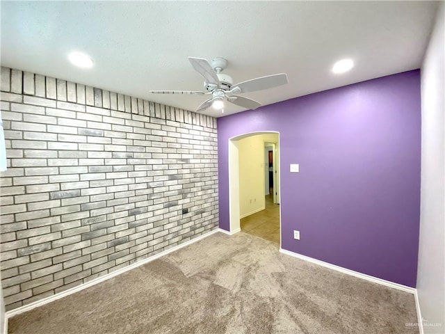 2508 Starling Cir W, Palmview, TX 78572 - unfurnished room with recessed lighting, ceiling fan, arched walkways, carpet flooring, and brick wall