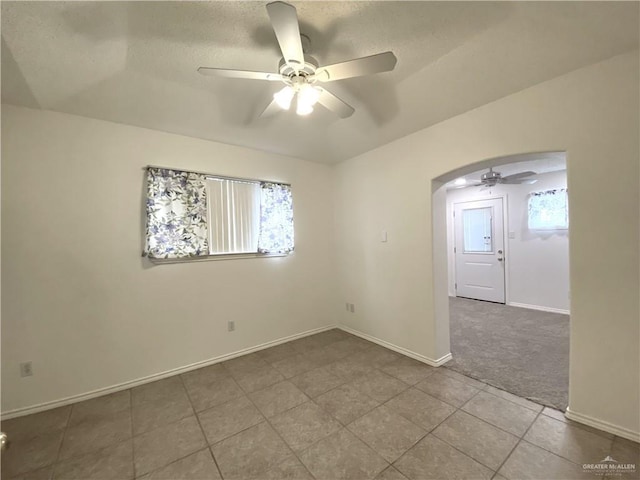 2508 Starling Cir W, Palmview, TX 78572 - tiled spare room featuring plenty of natural light, a ceiling fan, baseboards, and arched walkways