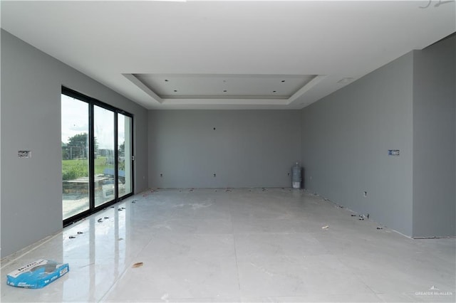 unfurnished room with a raised ceiling