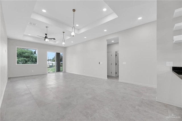 spare room featuring recessed lighting, baseboards, ceiling fan, visible vents, and a raised ceiling