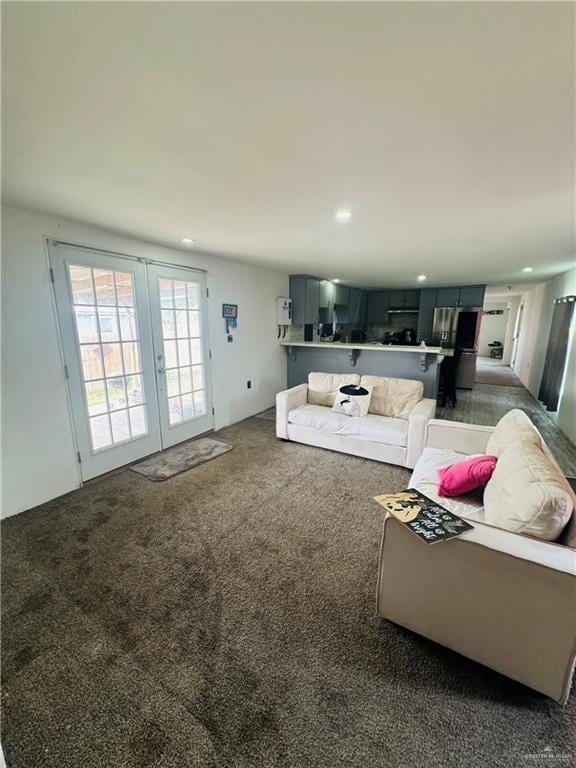 carpeted living area featuring recessed lighting and french doors