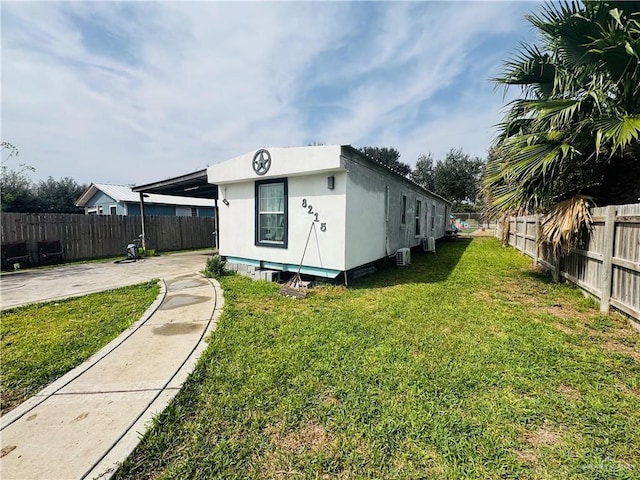 exterior space with a patio area, a fenced backyard, and a yard