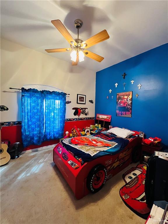 carpeted bedroom with a ceiling fan