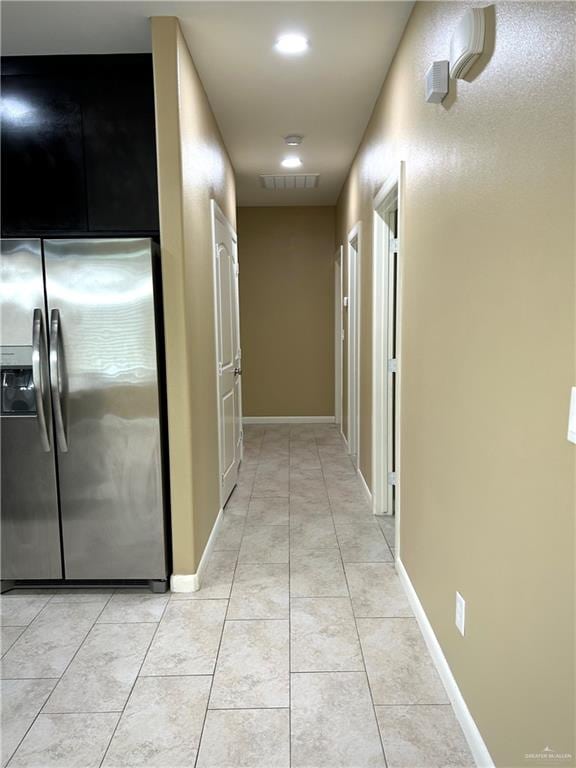 hall with light tile patterned floors