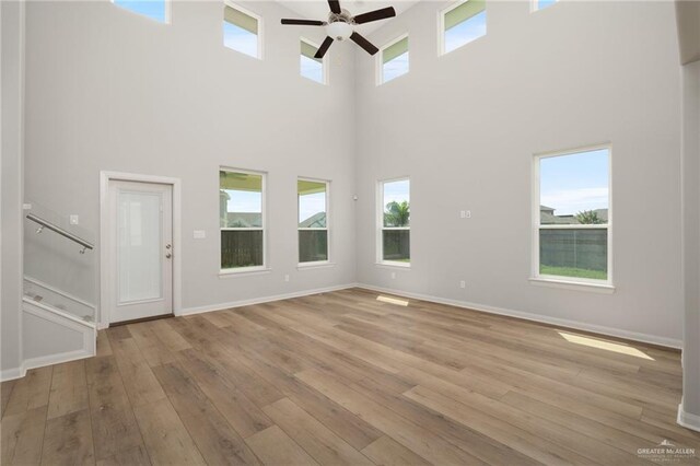 6300 Cascada Bend Rd, Mcallen, TX 78504 - empty room featuring a ceiling fan, hardwood / wood-style flooring, and a high ceiling