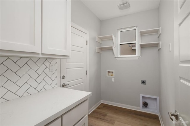 6300 Cascada Bend Rd, Mcallen, TX 78504 - washroom with electric dryer hookup, cabinet space, light wood-style flooring, and washer hookup