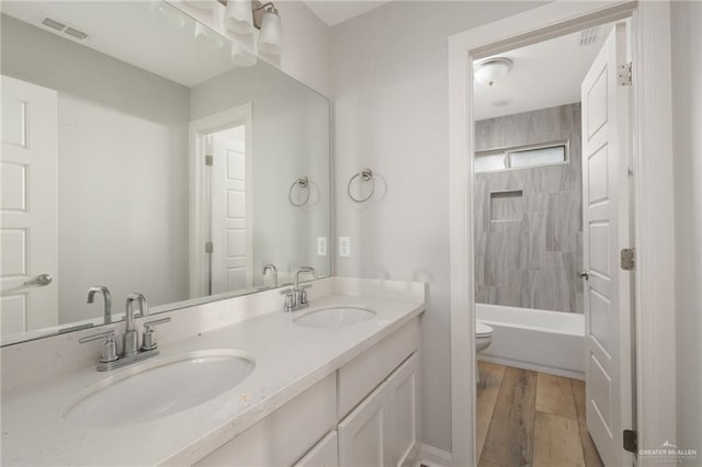 6300 Cascada Bend Rd, Mcallen, TX 78504 - bathroom with double vanity, shower / bath combination, and wood finished floors