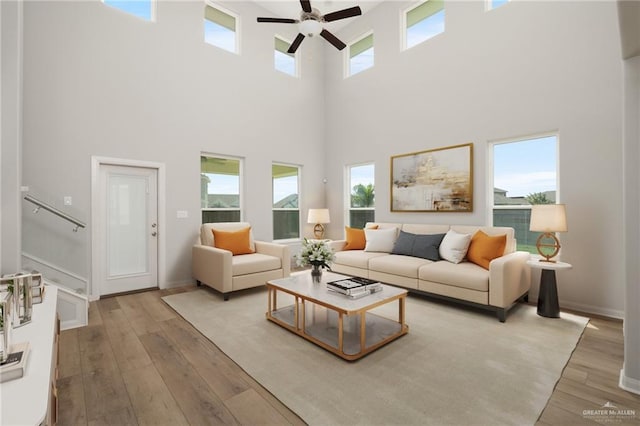 6300 Cascada Bend Rd, Mcallen, TX 78504 - living room with ceiling fan, a towering ceiling, hardwood / wood-style floors, and stairs