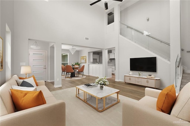 6300 Cascada Bend Rd, Mcallen, TX 78504 - living area with a towering ceiling, stairs, wood finished floors, and a ceiling fan