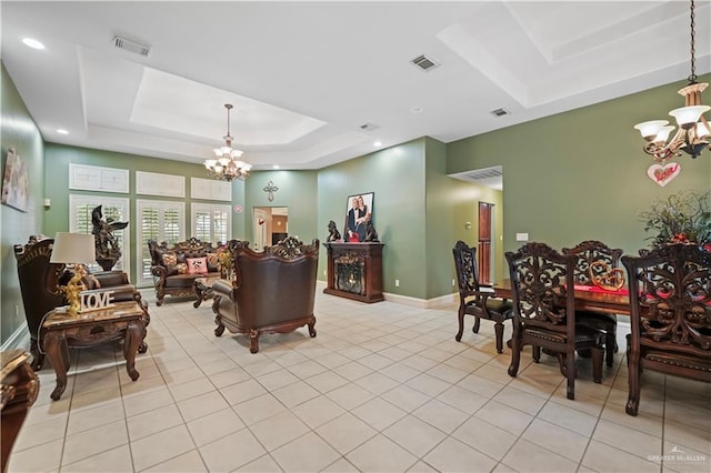 tiled living room with a notable chandelier and a tray ceiling