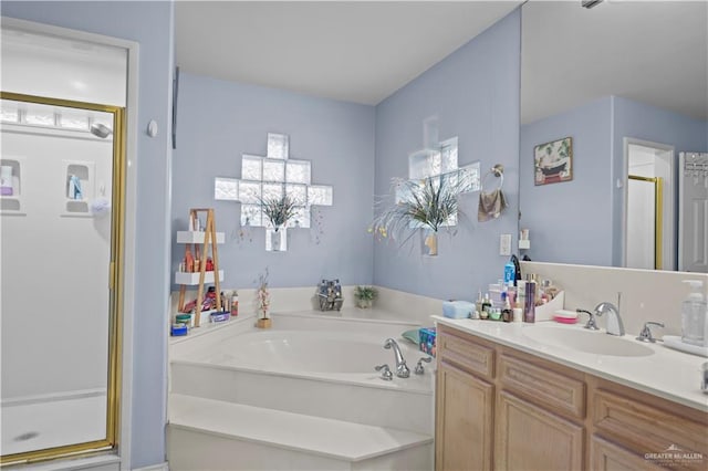 bathroom with vanity and independent shower and bath