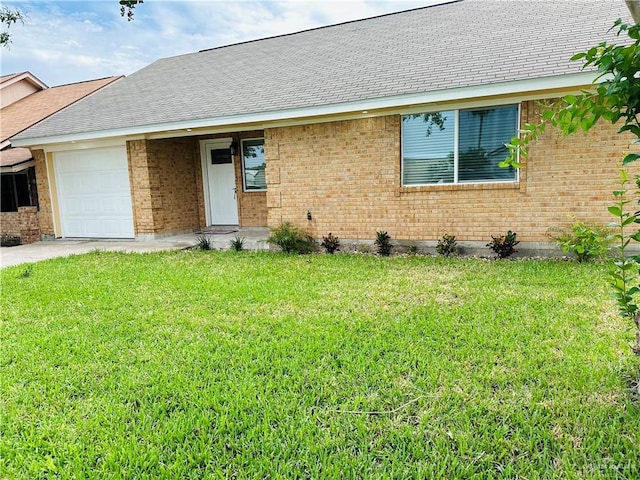 1523 Evergreen Ave, Mission, TX 78572 - ranch-style home featuring a garage, brick siding, a front yard, and roof with shingles