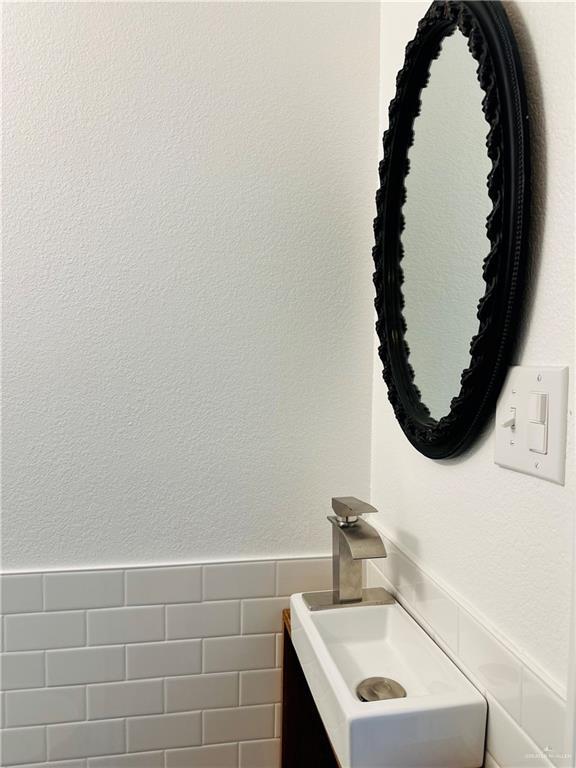 1523 Evergreen Ave, Mission, TX 78572 - bathroom with vanity and a wainscoted wall