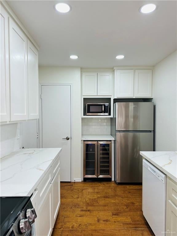 1523 Evergreen Ave, Mission, TX 78572 - kitchen featuring stainless steel appliances, wine cooler, white cabinetry, dark wood-style floors, and recessed lighting