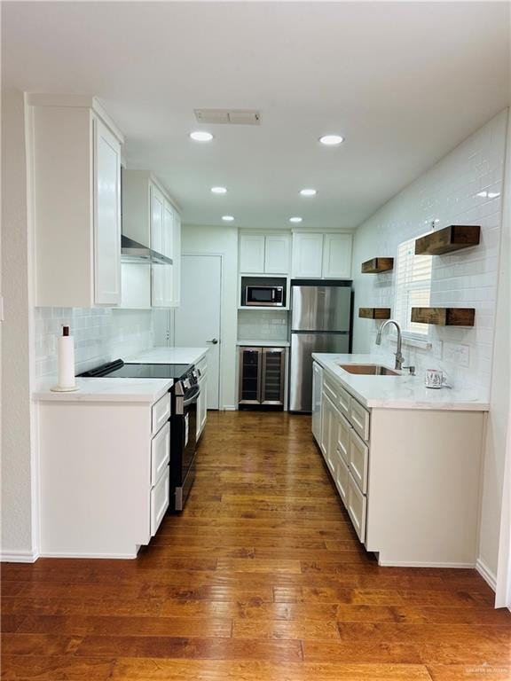 1523 Evergreen Ave, Mission, TX 78572 - kitchen with stainless steel appliances, open shelves, wood-type flooring, white cabinets, and light countertops