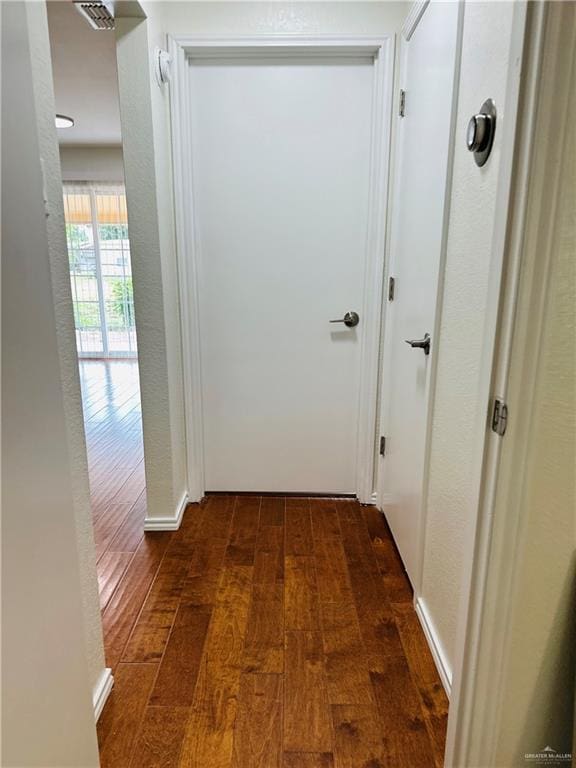 1523 Evergreen Ave, Mission, TX 78572 - corridor with dark wood-style floors and a textured wall
