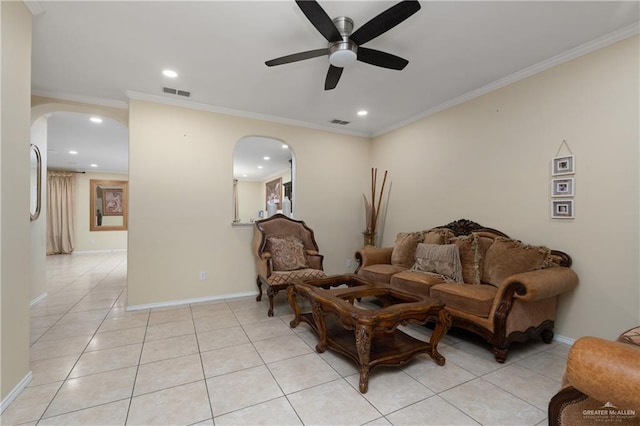 living area with light tile patterned floors, ceiling fan, and crown molding