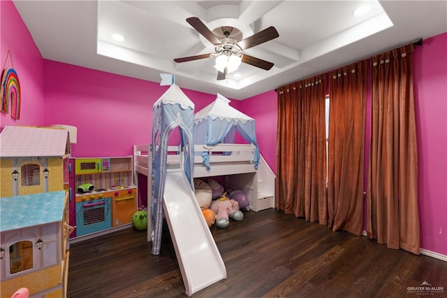 bedroom featuring ceiling fan, a raised ceiling, and dark wood-type flooring