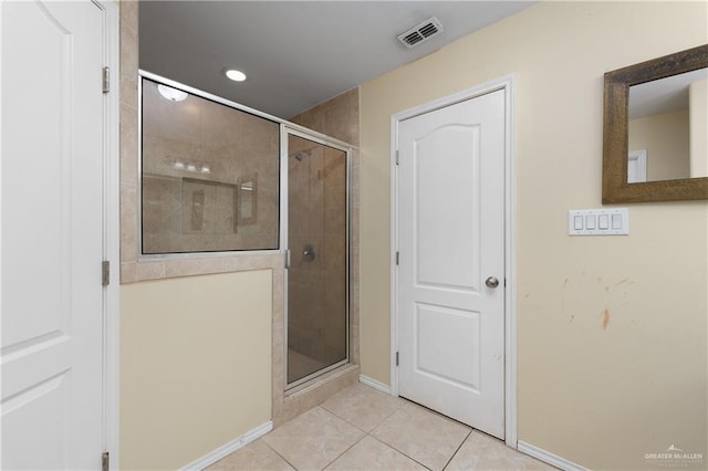 bathroom with tile patterned flooring and an enclosed shower