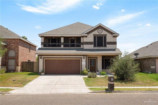 view of front of home with a garage, a balcony, and a front yard