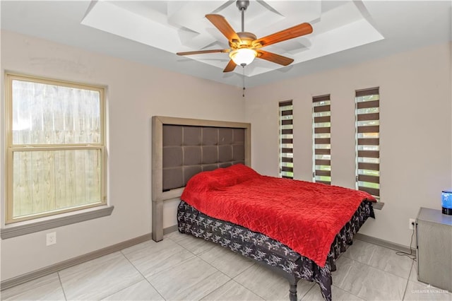 bedroom featuring a tray ceiling and ceiling fan